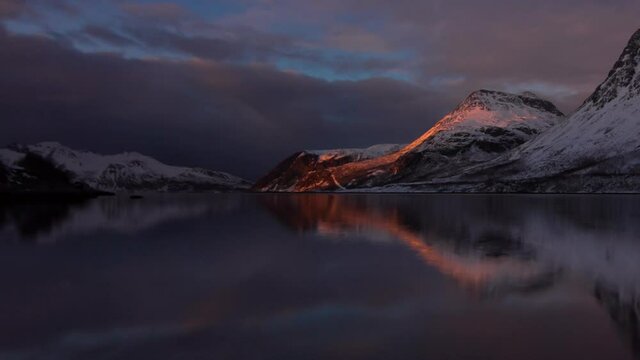 TIME LAPSE - Beautiful fjord near Tromso, Norway, night to day wide shot zoom out