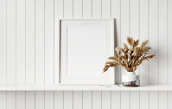 Mockup picture frame on white shelf. White planks wall background. 3D render. 3D illustration.