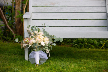 Wedding Bouquet of Roses Lean At The Bench