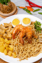 Mie rebus medan or Noodle Soup 

The dish is made of yellow egg noodles, which are also used in Hokkien mee, with a spicy slightly sweet curry-like gravy. The gravy is made from shrimp or tauchu broth