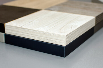 Samples laminate and parquet flooring. Multi-colored wood samples for the production of floors and skirting boards