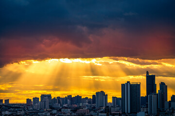 Fototapeta premium The high angle background of the city view with the secret light of the evening, blurring of night lights, showing the distribution of condominiums, dense homes in the capital community