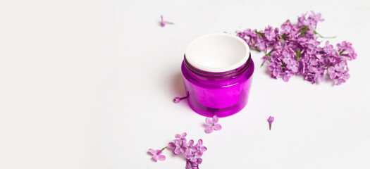 Lilac flowers with moisturizer on a white background. cosmetic skin care. natural cosmetic product. alternative herbal medicine. layout. copy space