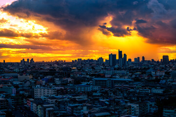The high angle background of the city view with the secret light of the evening, blurring of night lights, showing the distribution of condominiums, dense homes in the capital community