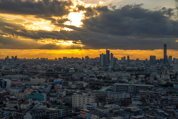 The high angle background of the city view with the secret light of the evening, blurring of night lights, showing the distribution of condominiums, dense homes in the capital community