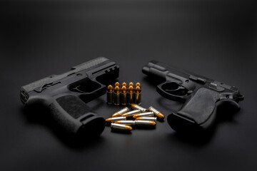Short pistol with ammunition placed on a dark black background.	