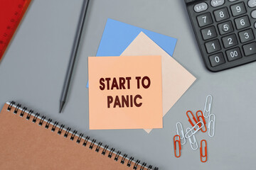 Start to Panic - concept of text on sticky note. Closeup of a personal agenda. Top view. Office concept