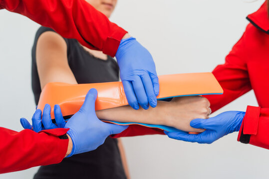 Injury leg. Young man with injured leg. Young woman doctor helps the patient. Close - up. First aid