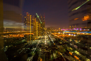 The high angle background of the city view with the secret light of the evening, blurring of night lights, showing the distribution of condominiums, dense homes in the capital community