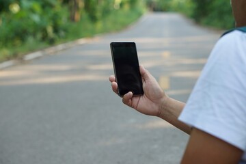 A traveler use smartphone to check and survey direction on the street. Concept lost the way. Checking internet signal. Using navigation application technology on smartphone