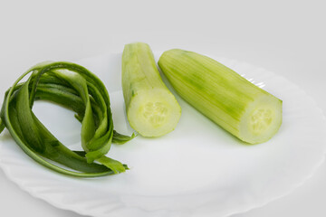 Peel off cucumbers and peels on a white background