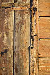Old wall of wooden planks with paint cracked .