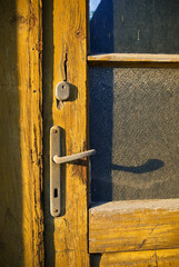 Old wall of wooden planks with paint cracked .