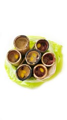 Sticky rice with coconut and taro steamed inside a piece of bamboo in plastic bag, Thai dessert, blurred and isolated on white background