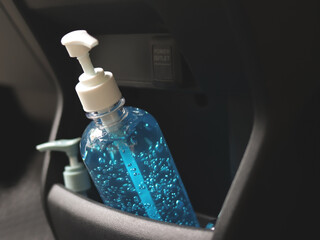 pump bottles  of alcohol sanitizer hand gel in car console storage. COVID19 prevention, transportation and new normal concept. - obrazy, fototapety, plakaty
