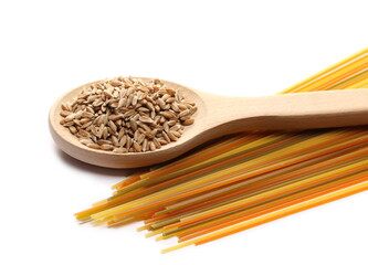 Spaghetti tricolore and spelt grains in wooden spoon isolated on white background