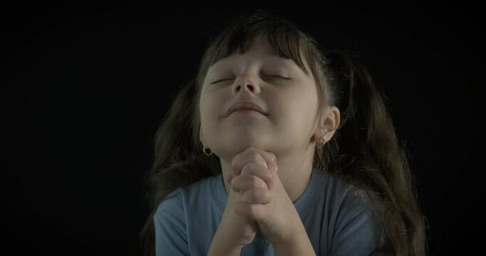 Young prayer in the night. A happy young girl stay and pray in the night.