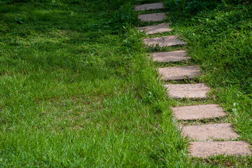 square cement walkway on grass