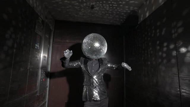 Mr disco ball dancing in a lift