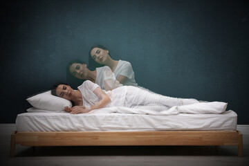 Somnambulist rising from bed near green wall indoors, multiple exposure. Sleepwalking