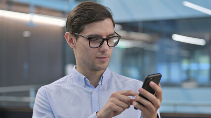 Portrait of Young Man using Smartphone