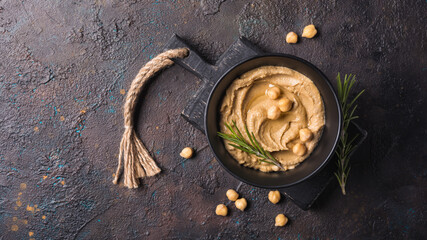 Bowl of tasty traditional homemade hummus with rosemary