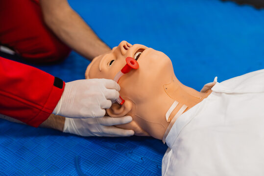 Medical manipulation for airway management. Nasopharyngeal tube airway insertion by stuff in a black gloves on a simulation mannequin dummy during medical training. ACLS