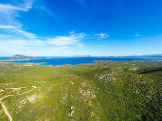 View from above, stunning aerial view of a mountain range covered by a green vegetation with...