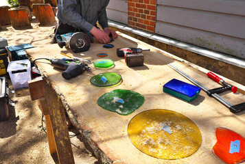 The carpenter works with a hand-held milling machine.