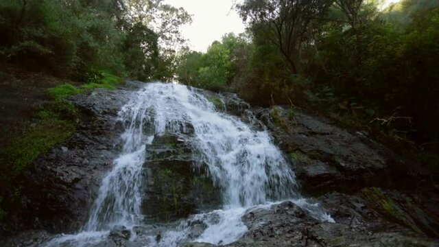 A waterfall cascading down a mountainside in the Paarl region of the Western Cape, South Africa.