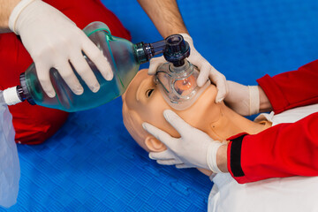 First Aid Training - CPR training medical procedure, Using an oxygen mask on a CPR dummy.