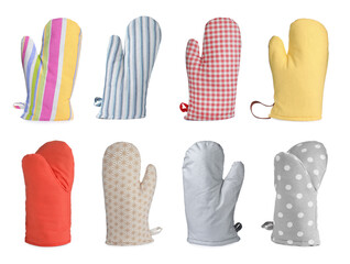 Set with different oven gloves on white background