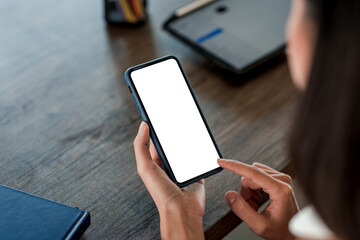Close up young lady hand holding a smartphone blank with white screen . Mock up.