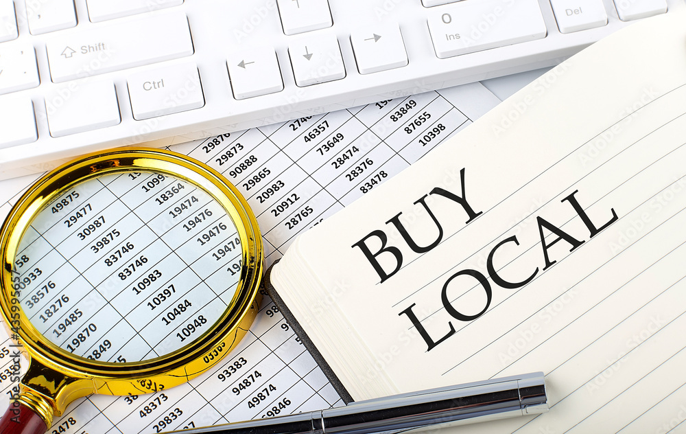 Poster buy local text on the notebook with chart, magnifier,keyboard and pen