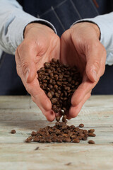 Closeup of a man holding coffe beans, selective focus