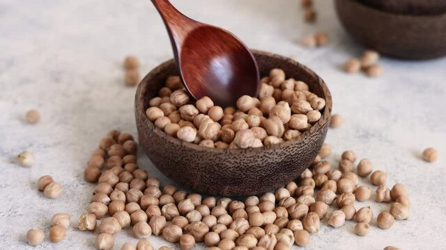 Raw dry chickpea in a wooden bowl close up