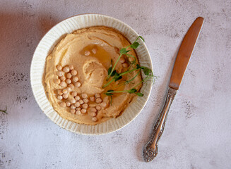 Hummus with olive oil and spices in the bowl
