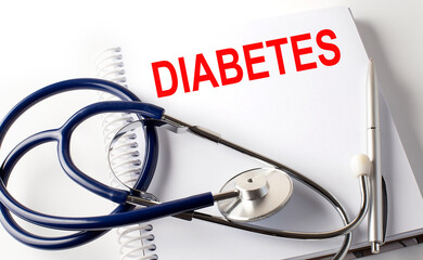Notebook with text DIABETES with pen and stethoscope