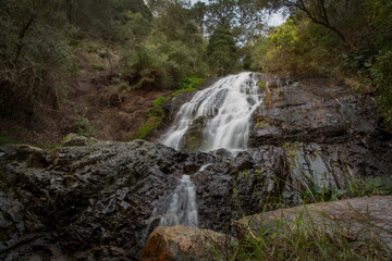 Fototapeta na wymiar A cascading waterfall in a mountain in the Paarl Region of the Western Cape, South Africa.