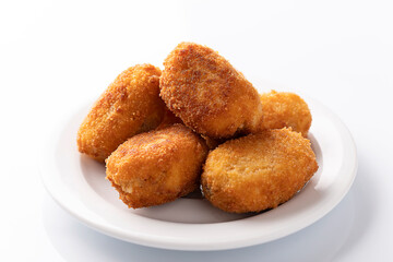 Tapa of croquetas, typical spanish dish, on white background