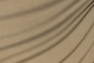 Fototapeta na wymiar Close-up texture of natural brown fabric or cloth in same color. Fabric texture of natural cotton, silk or wool, or linen textile material. Velvet canvas background.