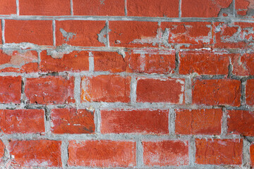 An old ragged imitation of a brick wall. Red brick, white grout.
