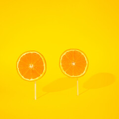 fresh oranges on a sunny yellow background.creative colorful summer idea