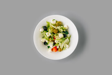 Greek salad on gray background. Top view.