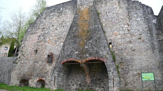 Ruins of an old blast furnace in village Dvor, Slovenia. Only walls remained. Ruins of mighty ironworks. Close up view of stones and bricks. Tilt up