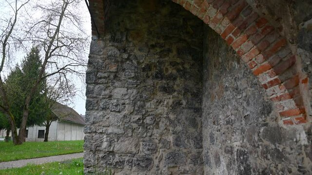 Ruins of an old blast furnace in village Dvor, Slovenia. Only walls remained. Ruins of mighty ironworks. Close up view of stones and bricks. Tilt up