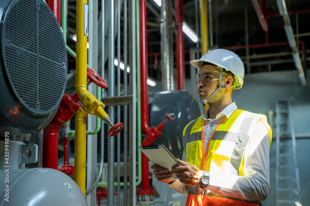 Fototapete Technician engineer checking controls system for security functions in service room at factory,Heating,Ventilation,Air Conditioning.