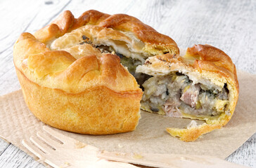 Close up of chicken and mushroom pie on a wooden table