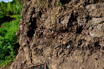 anthropocene soils with layers of waste layered in a soil probe. plastics characterize the hectic...