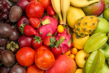 Assortment of fresh exotic fruits as background, top view